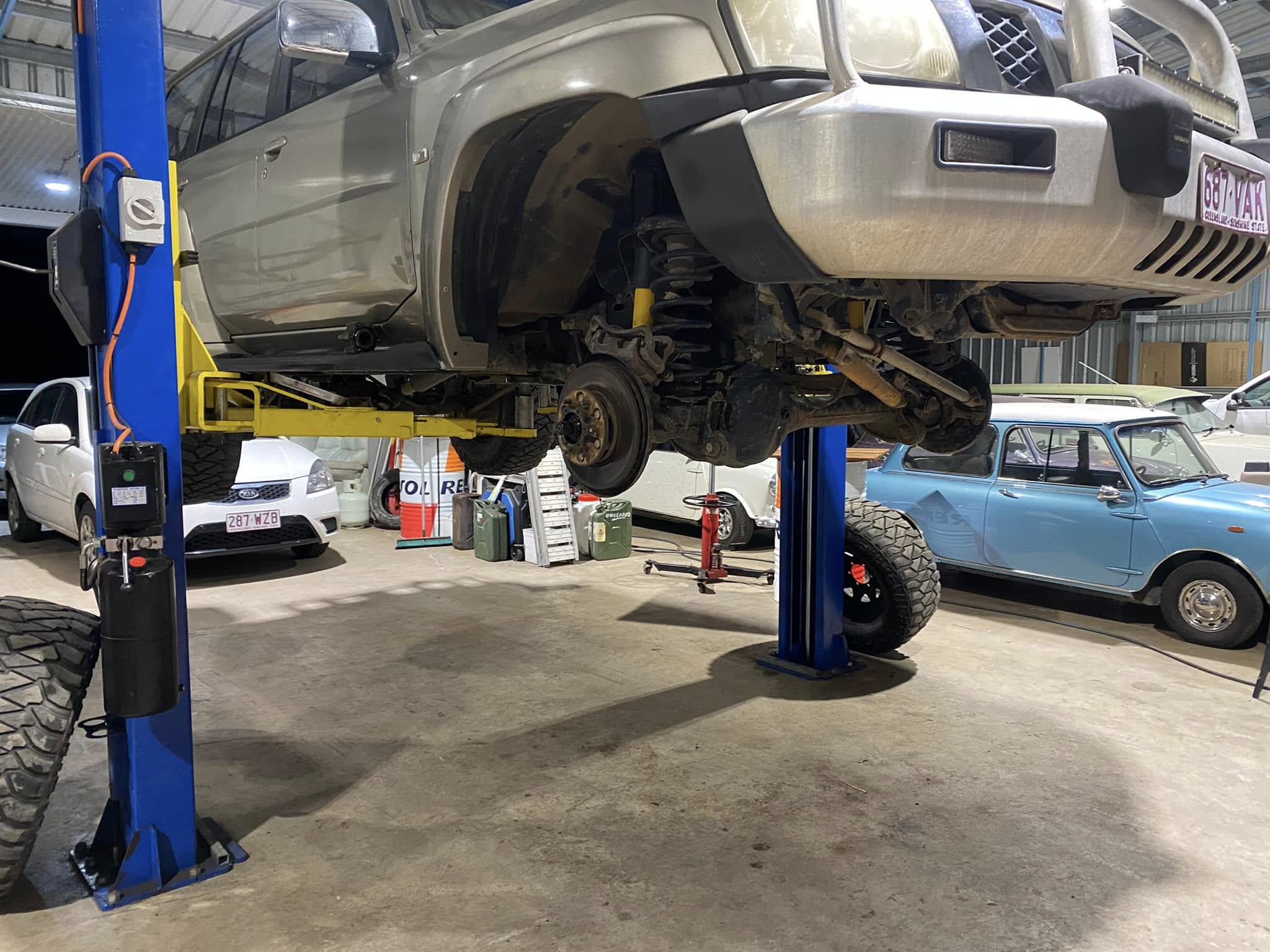 A 4WD up on the two-post hoist in the Absolute Automotive workshop in Ilkley, Sunshine Coast